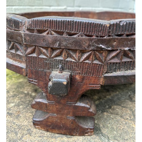 34 - An early 20thC Indian Chakki circular teak grinding table. Longest diameter 71cm w x 27cm h.