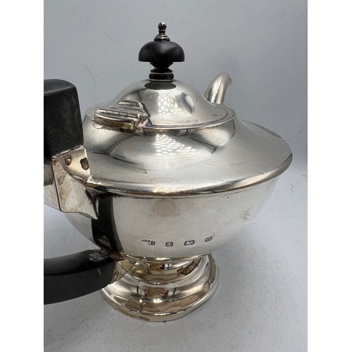 792 - Hallmarked silver teapot with ebony handle and knop. Birmingham 1938. Weight 439gm.