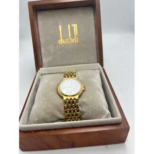 709 - Limited edition Dunhill Elite 18 carat gold wristwatch. Weight 71gm.