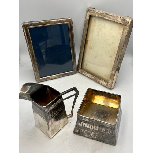 795 - Two hallmarked silver photograph frames and an Orivit Art Nouveau silver plated jug and sugar bowl. ... 