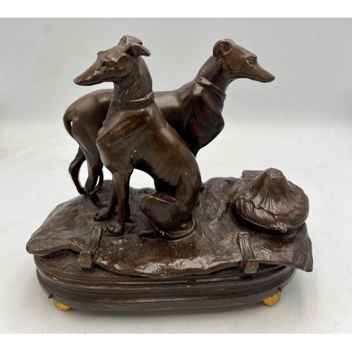 1181 - A cold painted bronze musical inkwell with seated and standing dogs to top. 14cm x 7cm.