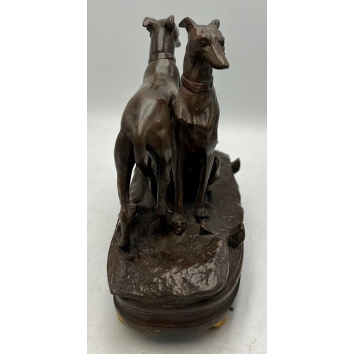 1181 - A cold painted bronze musical inkwell with seated and standing dogs to top. 14cm x 7cm.