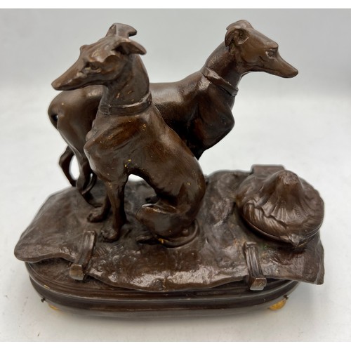 1181 - A cold painted bronze musical inkwell with seated and standing dogs to top. 14cm x 7cm.