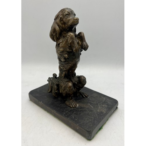 1183 - A bronze dog figure mounted on a slate base. 14cm h.