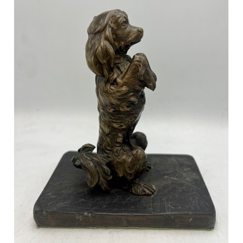 1183 - A bronze dog figure mounted on a slate base. 14cm h.