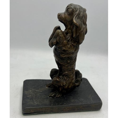 1183 - A bronze dog figure mounted on a slate base. 14cm h.