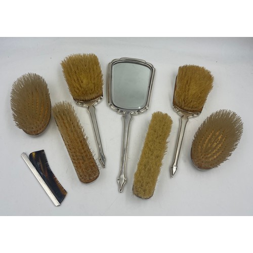 808 - Silver backed dressing table set comprising two hairbrushes, two clothes brushes, a mirror and a com... 