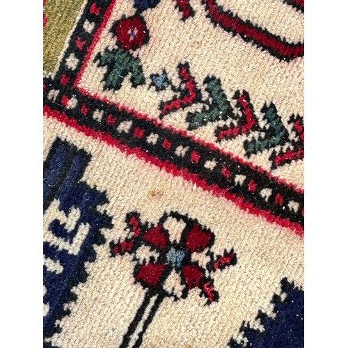 1103 - A red ground wool rug with panel designs. Approx. 167 x 280cm. (not including tassels).