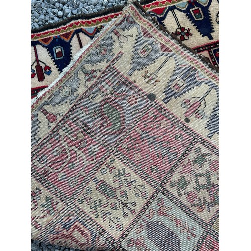 1103 - A red ground wool rug with panel designs. Approx. 167 x 280cm. (not including tassels).