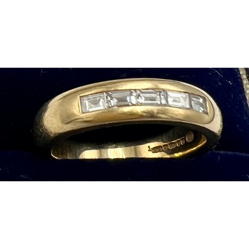 561 - An 18 carat gold half eternity ring set with baguette cut diamonds. Total diamond weight  0.45 carat... 