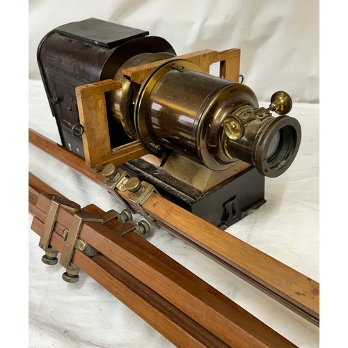 963 - A magic lantern slide projector with electric conversion  together with a wood and brass adjustable ... 