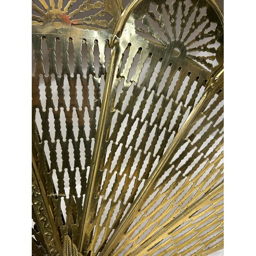 1190 - A vintage brass folding fan shaped fire guard, of peacock form, 63cm high x 95cm w extended together... 