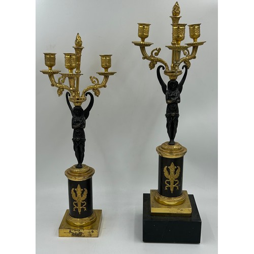 1192 - A pair of French 20thC gilt bronze 3 branch candelabras with winged figural columns and flame finial... 