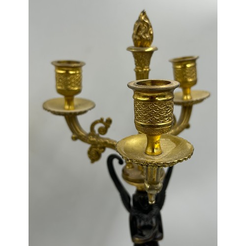 1192 - A pair of French 20thC gilt bronze 3 branch candelabras with winged figural columns and flame finial... 