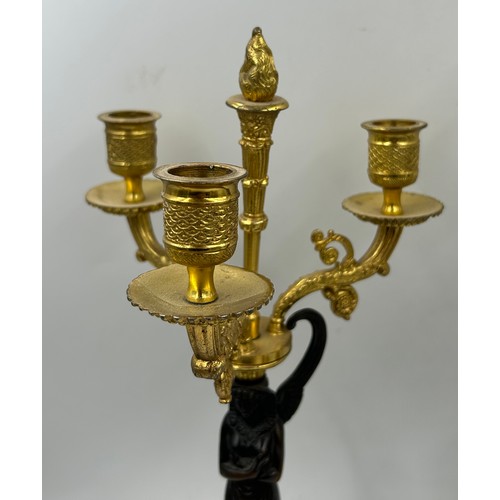 1192 - A pair of French 20thC gilt bronze 3 branch candelabras with winged figural columns and flame finial... 