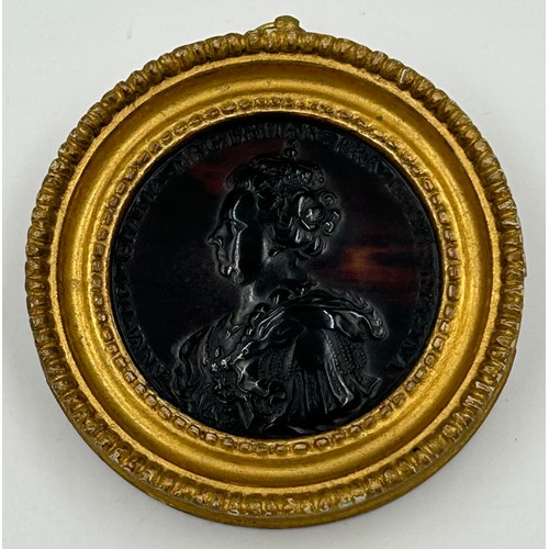 1193 - A Queen Anne tortoiseshell  Medallion mounted in a wooden gilt frame 9cm.