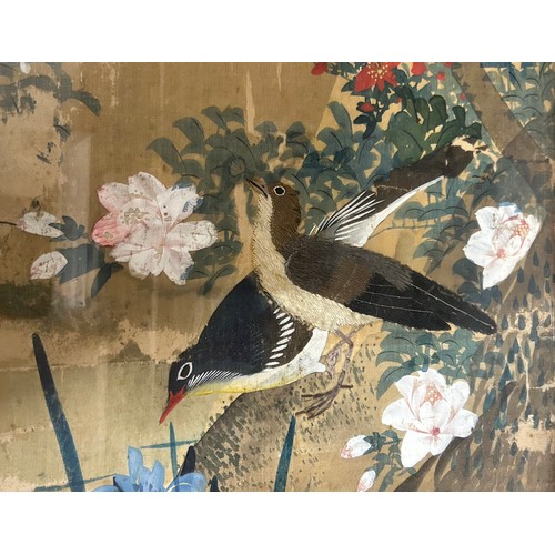 937 - A 19thC oriental silk painting of flowers and birds with two embroidered birds, mounted in a wooden ... 