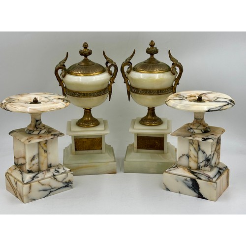 1200 - A pair of French stone garniture urns with twin handles and class plaques to the front, measuring 33... 