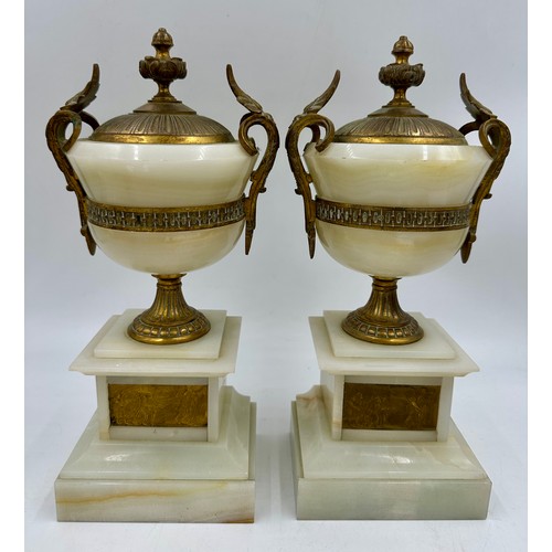 1200 - A pair of French stone garniture urns with twin handles and class plaques to the front, measuring 33... 