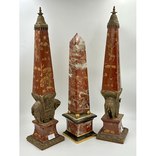 938 - A pair of Wong Lee ceramic and brass obelisks, decorated with deer, trees and butterflies mounted on... 