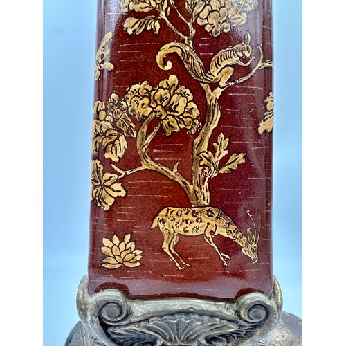 938 - A pair of Wong Lee ceramic and brass obelisks, decorated with deer, trees and butterflies mounted on... 