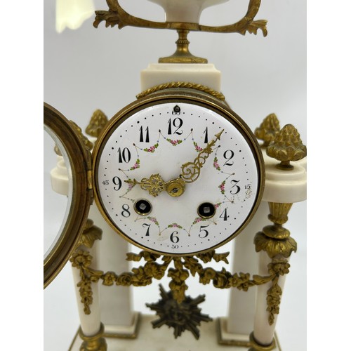 990 - A French Empire style white marble mantel clock decorated with garlands and ribbons. Movement marked... 