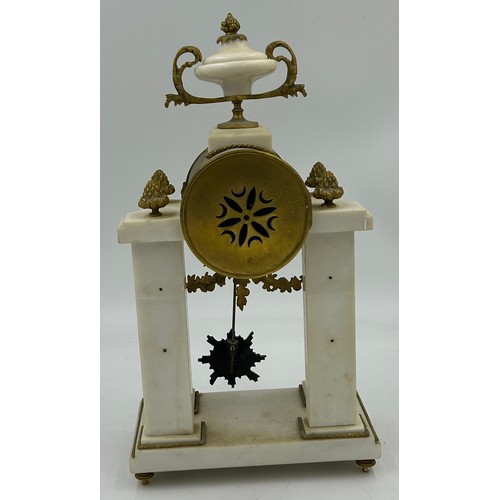 990 - A French Empire style white marble mantel clock decorated with garlands and ribbons. Movement marked... 