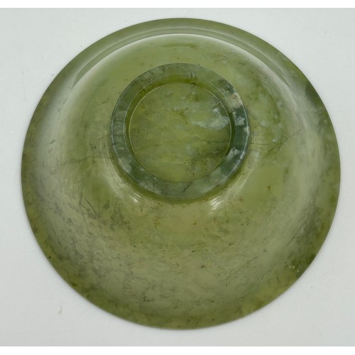 1210 - A Chinese small jade bowl on a wooden stand, 9.8cm diameter, height 4.8cm (excluding stand) together... 