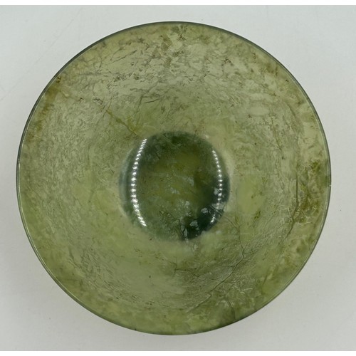 1210 - A Chinese small jade bowl on a wooden stand, 9.8cm diameter, height 4.8cm (excluding stand) together... 