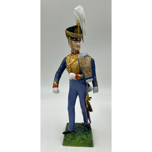 403 - A collection of four Dresden Soldier figurines to include Officer of Royal Artillery Horse Brigade, ... 