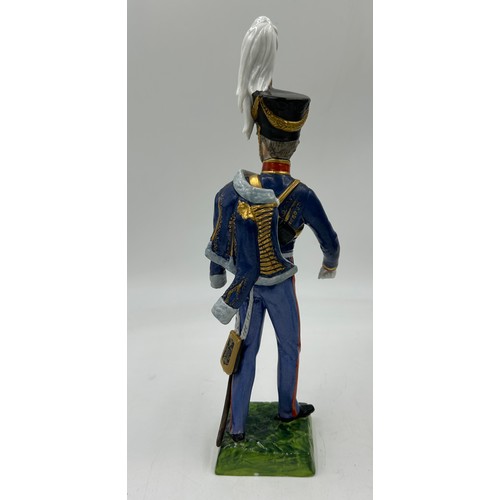 403 - A collection of four Dresden Soldier figurines to include Officer of Royal Artillery Horse Brigade, ... 