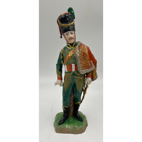 403 - A collection of four Dresden Soldier figurines to include Officer of Royal Artillery Horse Brigade, ... 