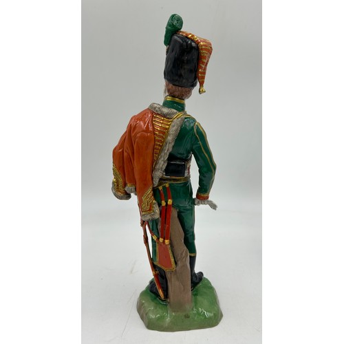 403 - A collection of four Dresden Soldier figurines to include Officer of Royal Artillery Horse Brigade, ... 