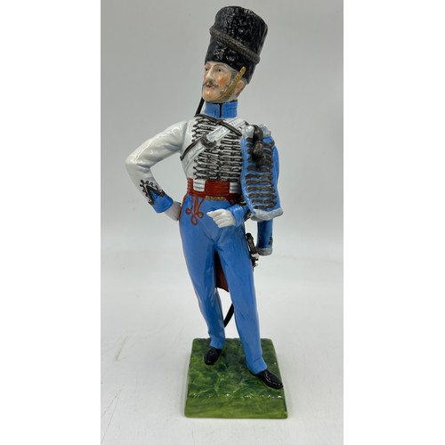 403 - A collection of four Dresden Soldier figurines to include Officer of Royal Artillery Horse Brigade, ... 