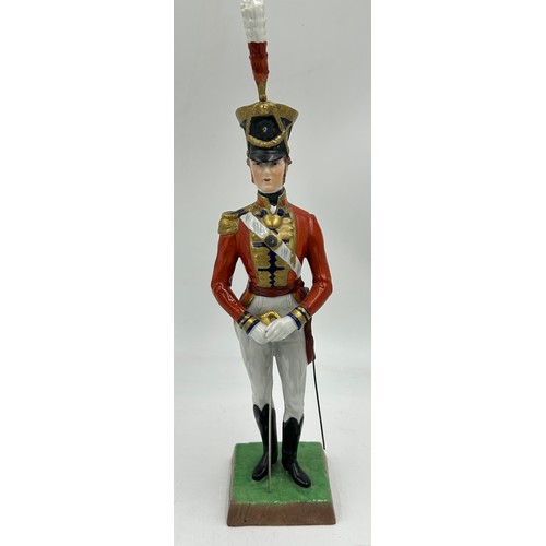 403 - A collection of four Dresden Soldier figurines to include Officer of Royal Artillery Horse Brigade, ... 