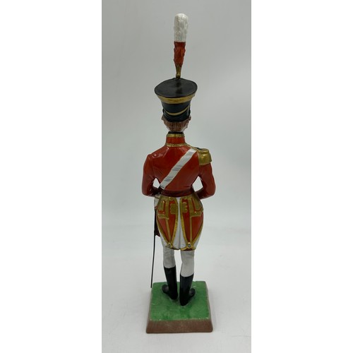 403 - A collection of four Dresden Soldier figurines to include Officer of Royal Artillery Horse Brigade, ... 