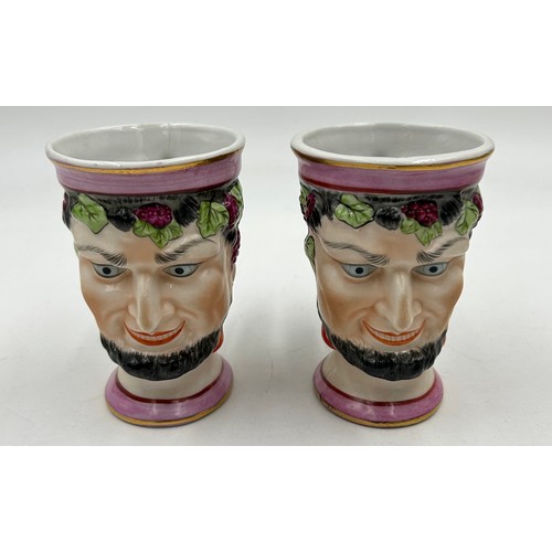 409 - Ceramics to include two Staffordshire lidded jars, a pair of Staffordshire Bacchus God of wine cups,... 