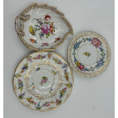 412 - A collection of Dresden porcelain to include a matching cup and saucer, 2 x white floral cups with o... 