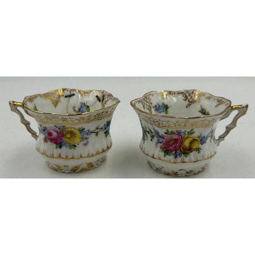 412 - A collection of Dresden porcelain to include a matching cup and saucer, 2 x white floral cups with o... 