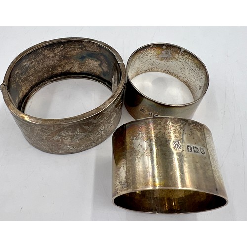 819 - Two hallmarked silver napkin rings together with a white metal bracelet marked sterling silver. Tota... 