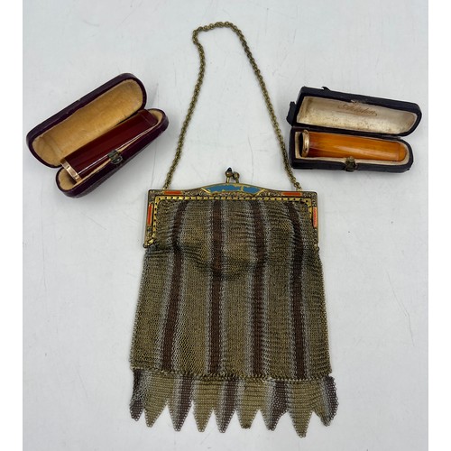 1222 - Two cased amber cheroot holders with yellow metal mounts together with a metal mesh evening bag.