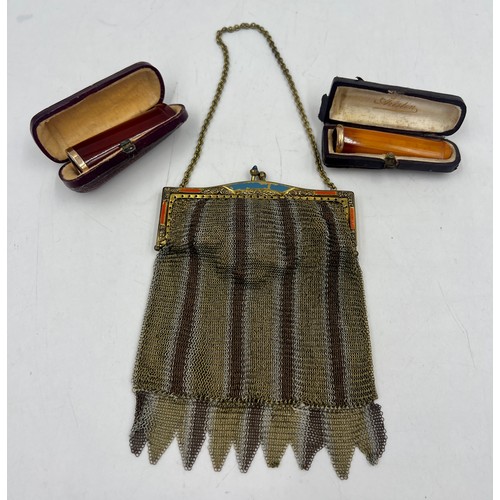 1222 - Two cased amber cheroot holders with yellow metal mounts together with a metal mesh evening bag.