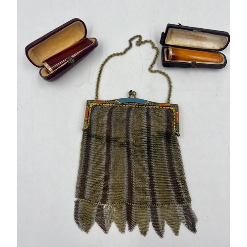 1222 - Two cased amber cheroot holders with yellow metal mounts together with a metal mesh evening bag.