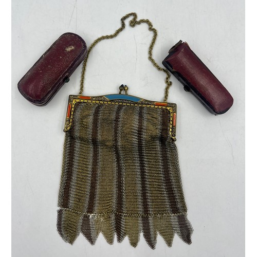 1222 - Two cased amber cheroot holders with yellow metal mounts together with a metal mesh evening bag.