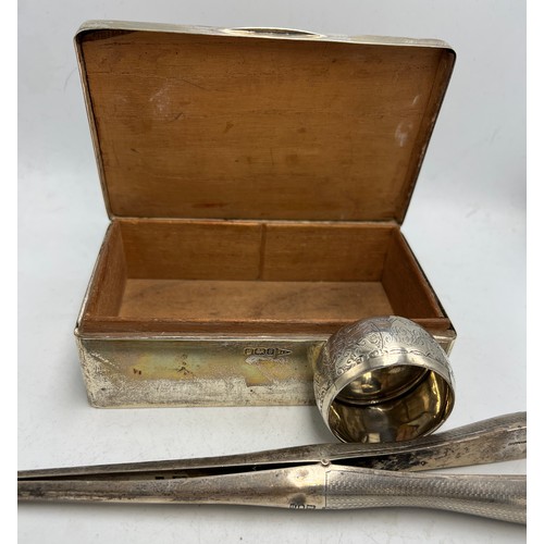 820 - Hallmarked silver to include cigarette box, napkin ring and glove stretchers. Various dates and make... 