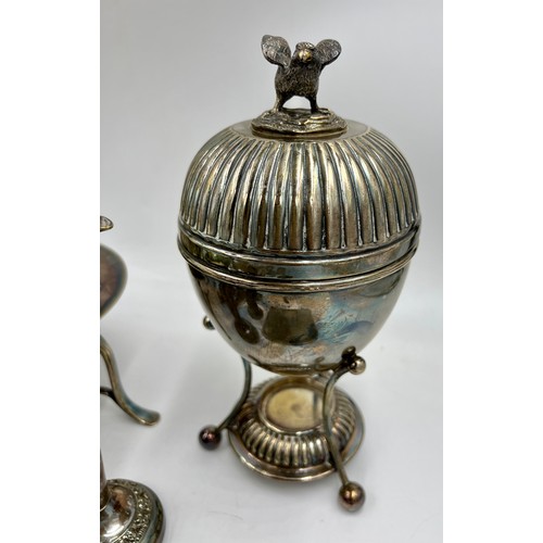 769 - A quantity of silver plated items to include egg coddler, kettle, inkwell, hip flask, napkin ring et... 