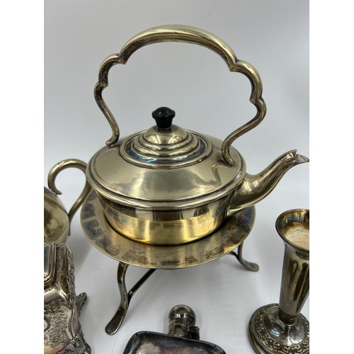 769 - A quantity of silver plated items to include egg coddler, kettle, inkwell, hip flask, napkin ring et... 