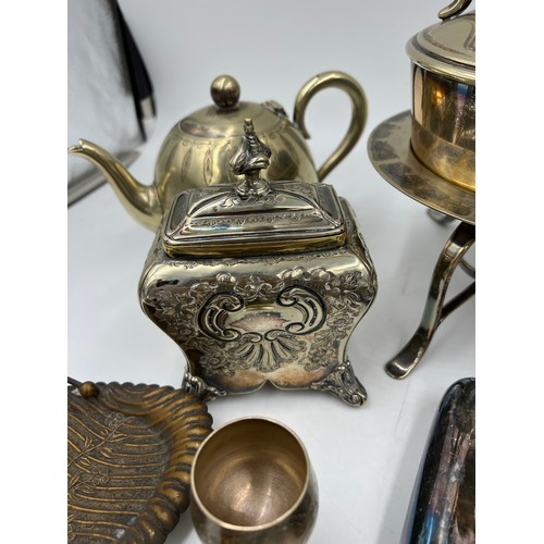 769 - A quantity of silver plated items to include egg coddler, kettle, inkwell, hip flask, napkin ring et... 