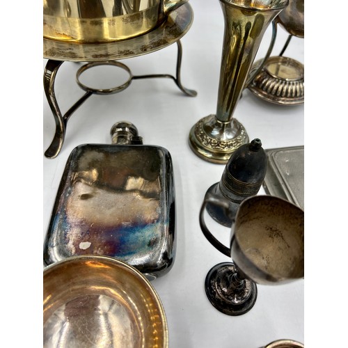 769 - A quantity of silver plated items to include egg coddler, kettle, inkwell, hip flask, napkin ring et... 