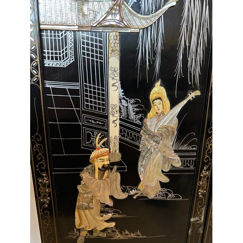 1224 - A pair of 20thC decorative wall panels depicting oriental scenes with mother of pearl embellishment ... 